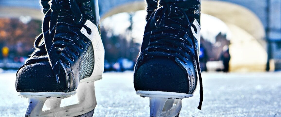 close-up photo of black-and-gray Intruder ice skates on frozen body of water