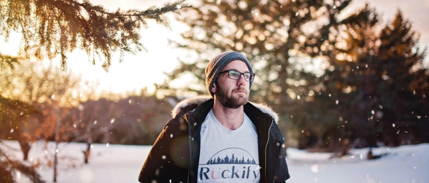 man standing on snow field during daytime
