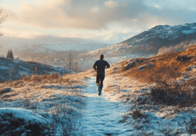 Bildens beskrivning: En man springer genom ett snöklätt, solbelyst landskap, omgiven av berg och natur. Morgonljuset skapar en harmonisk och inspirerande atmosfär. Midcent: Sport.