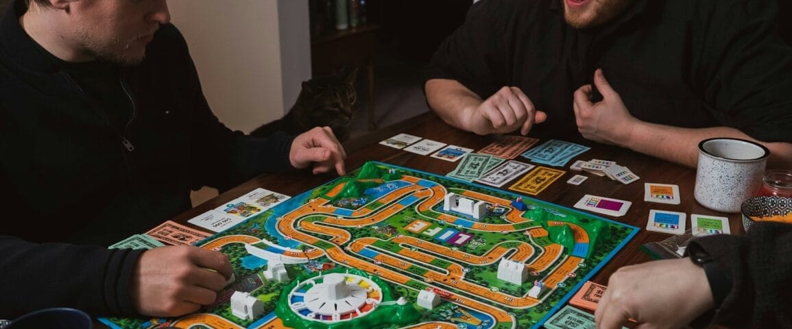 two men playing a game of monopoly on a table