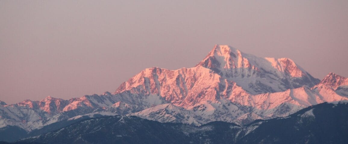 brown and white mountain under gray sky