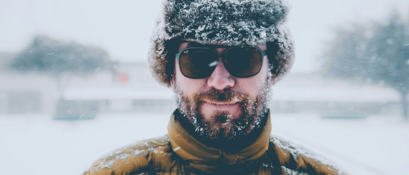 man wearing brown bubble jacket with black hat