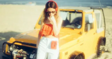 woman standing near yellow vehicle