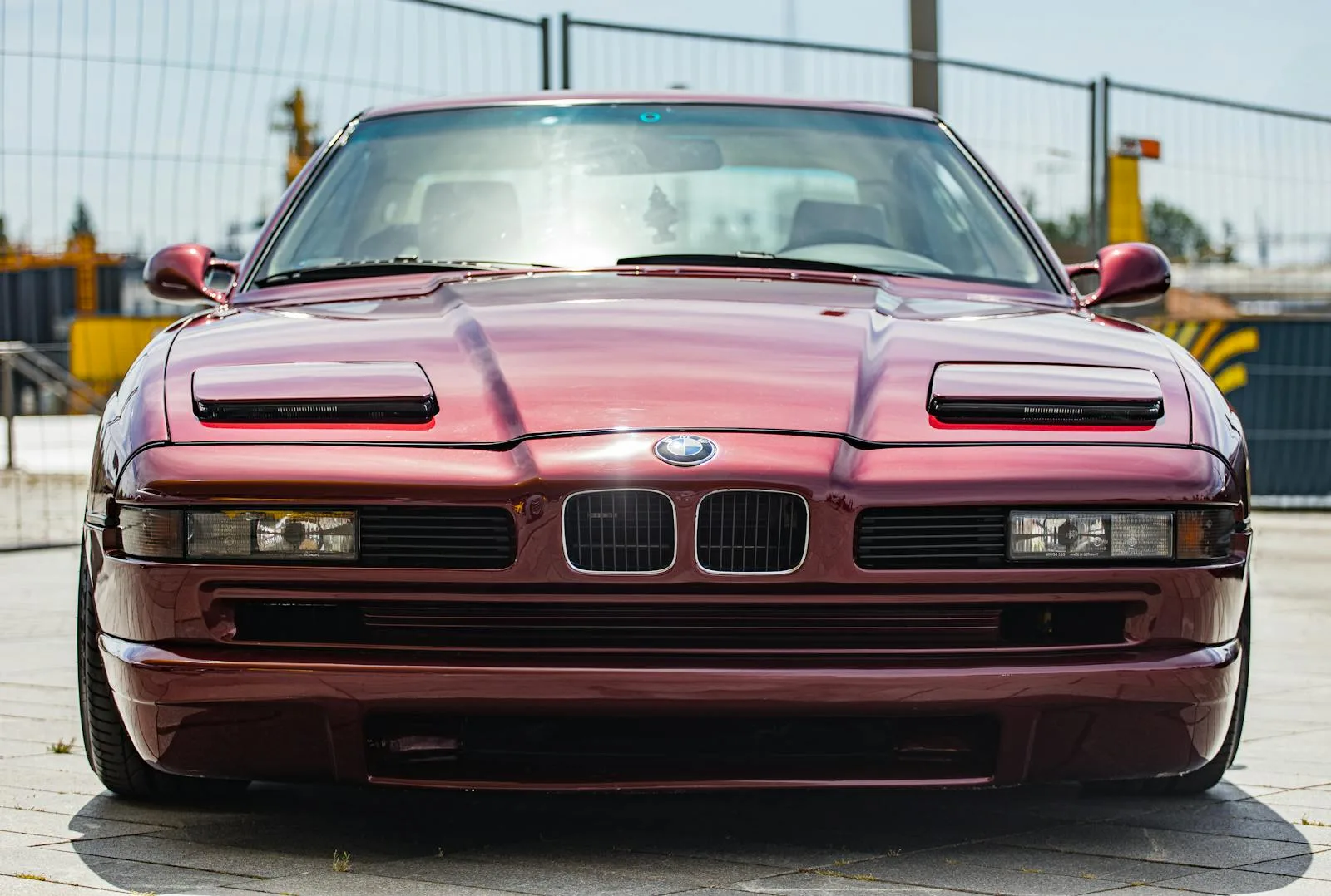 Front view of a vintage red BMW sports car showcasing its timeless style and design.