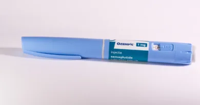A blue pen sitting on top of a white table