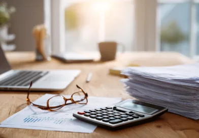 Midcent: Effektiv arbetsmiljö med laptop, papper och kalkylator. Perfekt för produktivitet och organisation. Kategorin är Ekonomi.