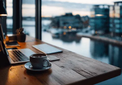 Midcent - En stilren arbetsplats med dator och kaffekopp framför fönster med vacker vy över stadsvatten. Perfekt för inspiration och produktivitet. Ekonomi.